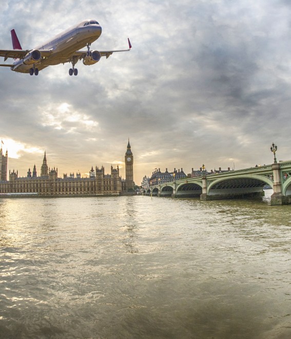 Jumbo Jet flying above London Big Ben and Tower Bridge