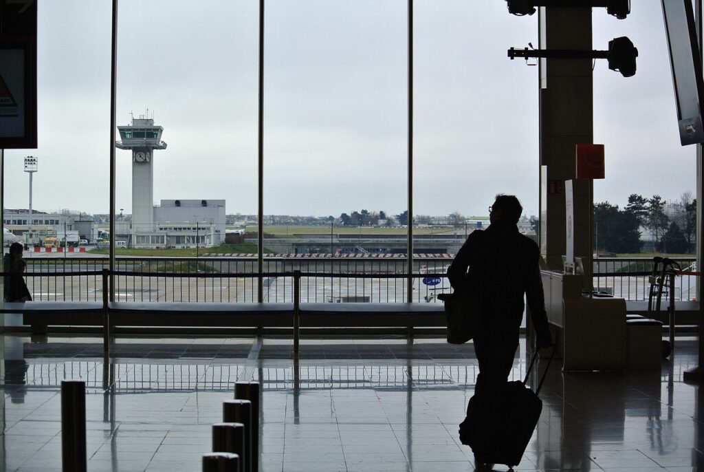 Business travel - Indian businessman walking towards an airport lounge