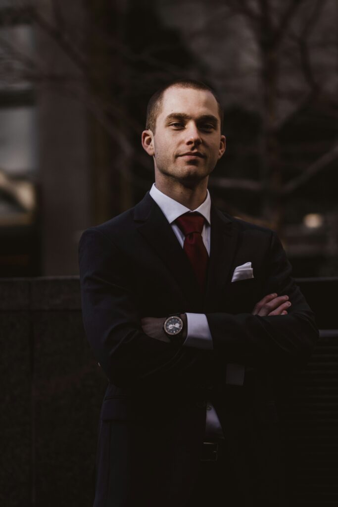 Executive Director in a suit with his arms crossed over