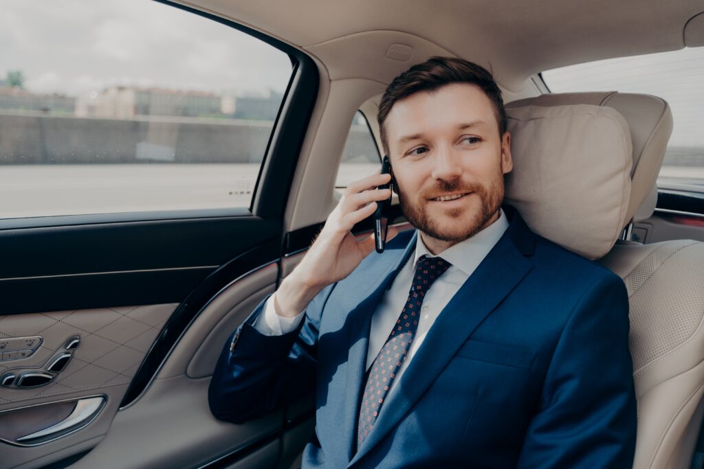 young good looking businessman taking ride to conference